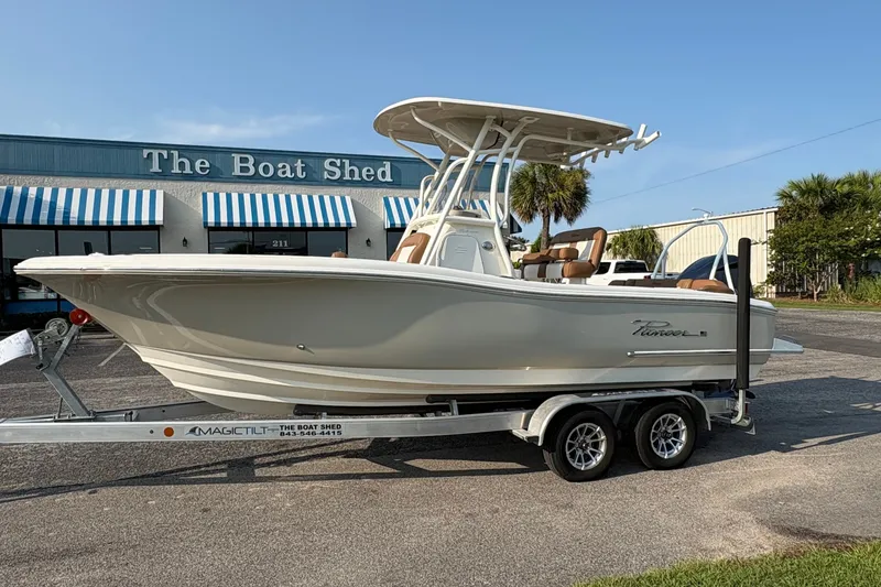 The Image of 2027 Pioneer 222 Islander boat on trailer outside The Boat Shed dealership. - 1