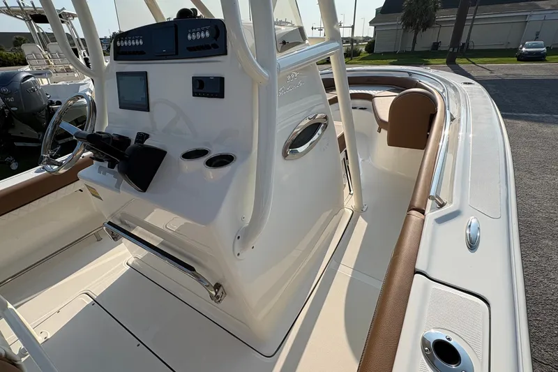 Slide: The Image of 2027 Pioneer 222 Islander boat interior with steering console and seating area. - 20