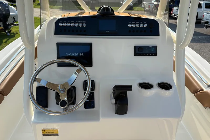 Slide: The Image of 2027 Pioneer 222 Islander boat dashboard with Garmin display and Yamaha controls. - 15
