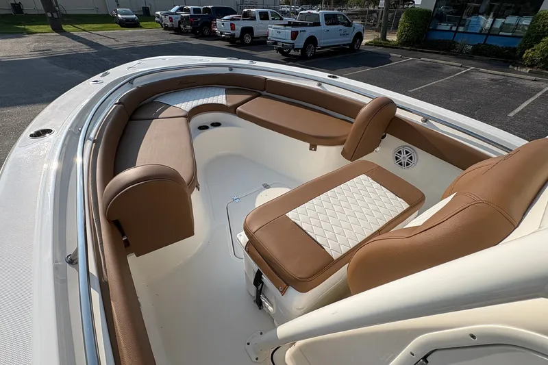 Slide: The Image of 2027 Pioneer 222 Islander boat interior with brown seating and white accents. - 23