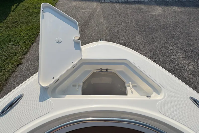 Slide: The Image of Open storage compartment on 2027 Pioneer 222 Islander boat, showcasing spacious design. - 29