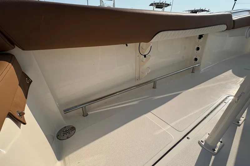 Slide: The Image of Interior view of 2027 Pioneer 222 Islander boat, featuring sleek seating and stainless steel railing. - 18