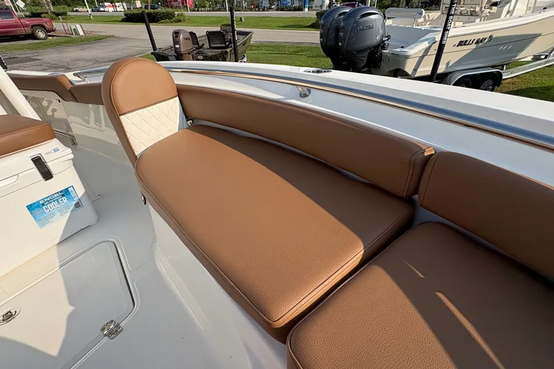 Slide: The Image of 2027 Pioneer 222 Islander boat with tan seating and Engel cooler on deck. - 27
