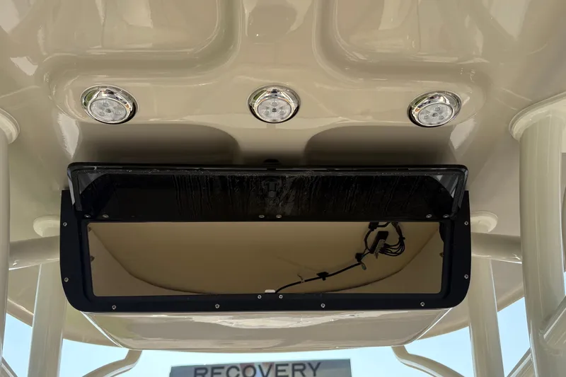 Slide: The Image of 2027 Pioneer 222 Islander boat ceiling with built-in lights and storage compartment. - 14