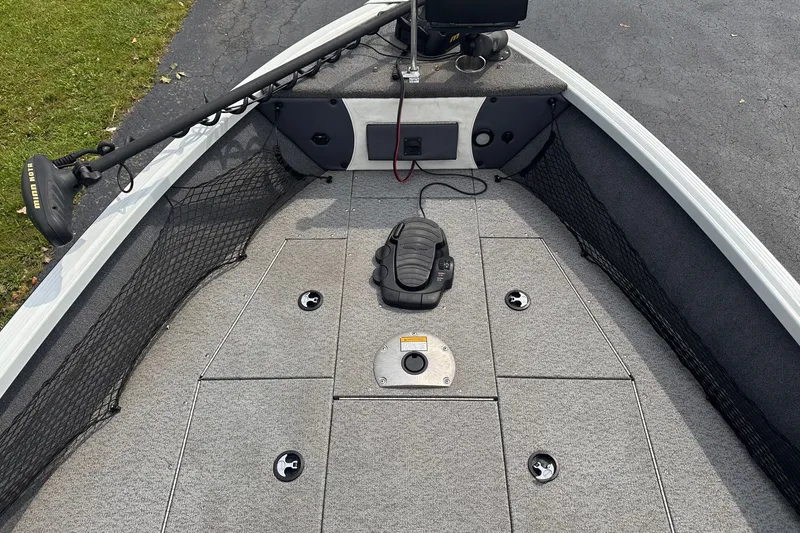 Slide: The Image of 2013 Alumacraft Competitor 185 Sport boat interior with trolling motor and storage compartments. - 10