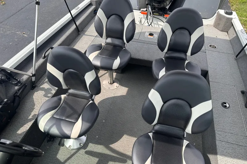 Slide: The Image of 2013 Alumacraft Competitor 185 Sport boat interior with four black and white cushioned seats. - 7