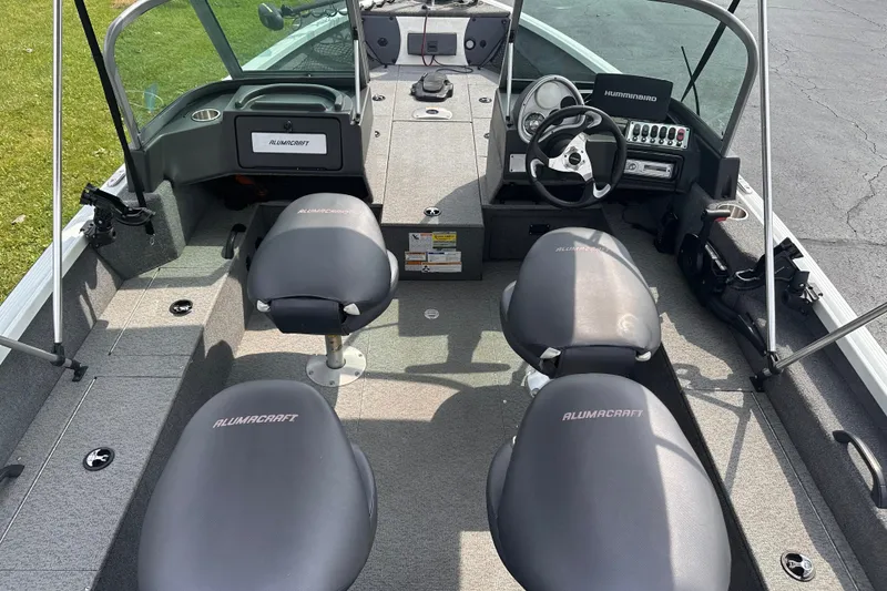 Slide: The Image of 2013 Alumacraft Competitor 185 Sport boat interior with steering console and seating. - 8