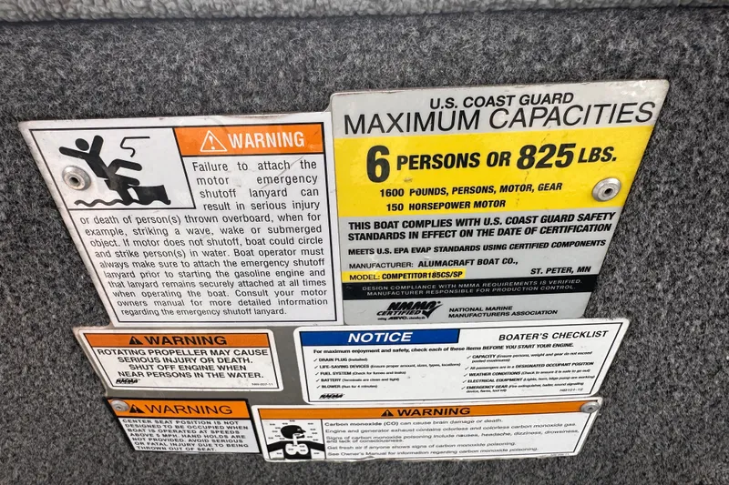 Slide: The Image of Safety and capacity warnings on a 2013 Alumacraft Competitor 185 Sport boat. - 31