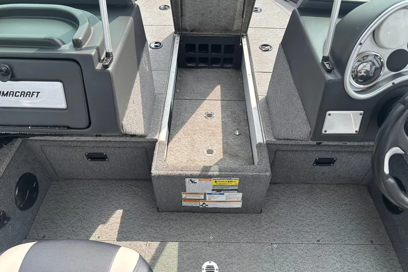 Slide: The Image of Interior view of a 2013 Alumacraft Competitor 185 Sport boat, showcasing seating and storage. - 19