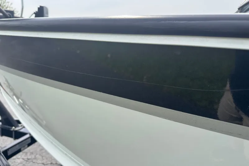 Slide: The Image of 2013 Alumacraft Competitor 185 Sport boat side view with sleek black and white design. - 27