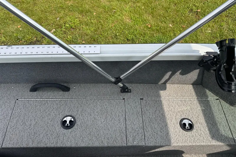 Slide: The Image of 2013 Alumacraft Competitor 185 Sport boat interior with storage compartments and measuring ruler. - 23