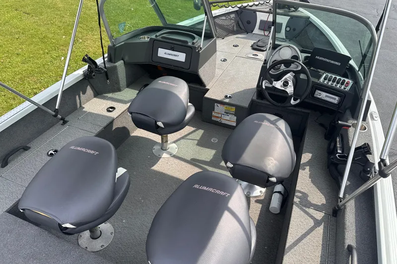 Slide: The Image of 2013 Alumacraft Competitor 185 Sport boat interior with seating and steering console. - 9