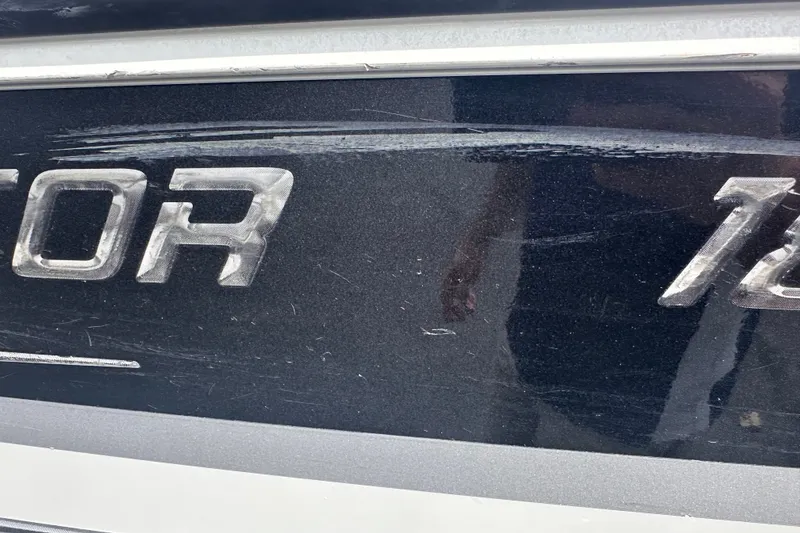 Slide: The Image of Close-up of Alumacraft Competitor 185 Sport 2013 boat lettering with visible scratches. - 29