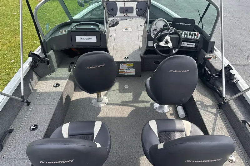 Slide: The Image of 2013 Alumacraft Competitor 185 Sport boat interior with steering wheel and seating. - 6