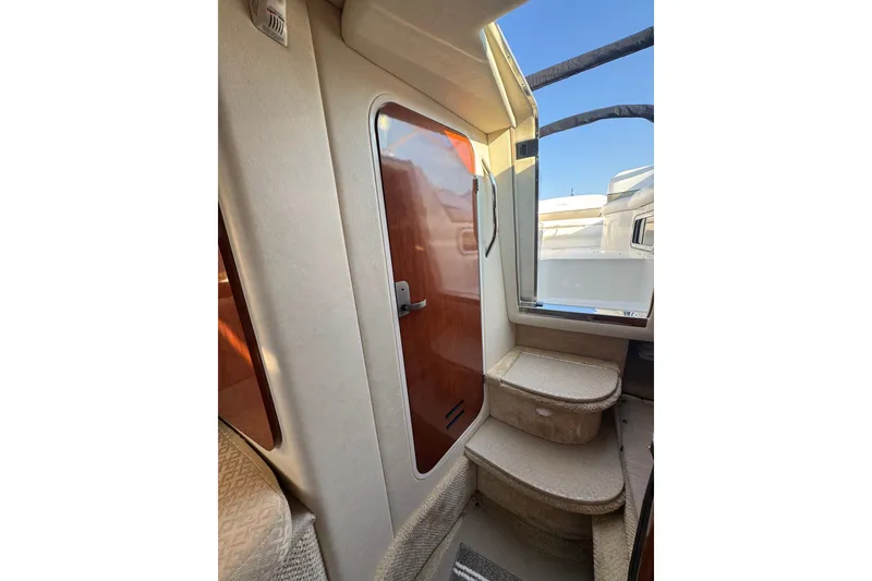 Slide: The Image of Interior view of 2006 Searay 260 boat with steps and wooden door. - 33
