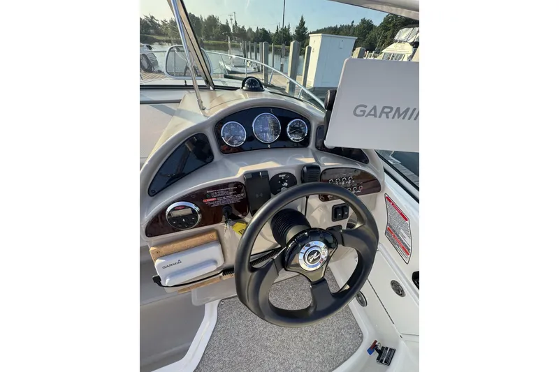 Slide: The Image of Helm of 2006 Sea Ray 270 Sundancer with Garmin navigation system and steering wheel. - 9