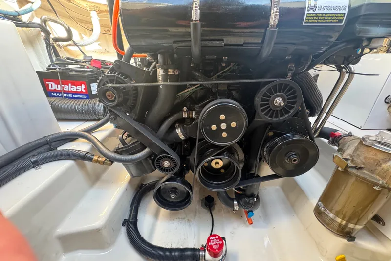 Slide: The Image of Engine compartment of a 2006 Searay 260 boat with visible components and Duralast battery. - 25