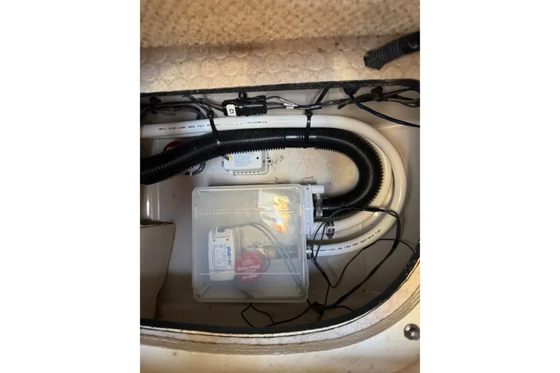 Slide: The Image of 2006 Searay 260 boat interior showing bilge pump and wiring setup. - 28