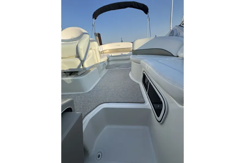 Slide: The Image of Interior view of 2006 Sea Ray 270 Sundancer boat with white seating and carpeted floor. - 19