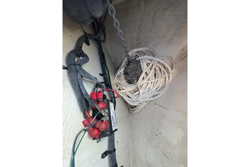 Slide: The Image of Coiled rope and wiring inside a 2006 Sea Ray 270 Sundancer boat compartment. - 37