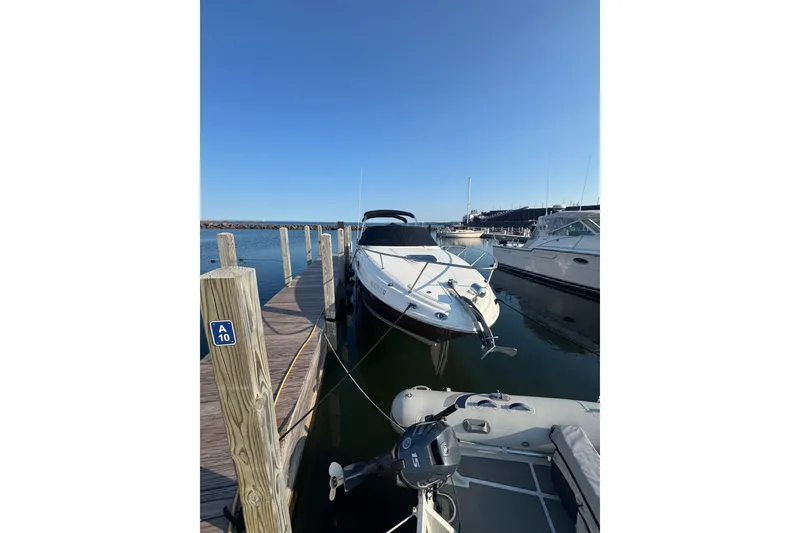 Slide: The Image of 2006 Searay 260 boat docked at marina under clear blue sky. - 4