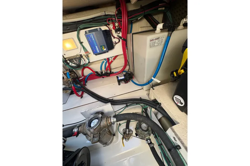 Slide: The Image of Engine compartment of a 2006 Searay 260 boat, showcasing wiring and components. - 23