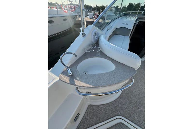 Slide: The Image of 2006 Searay 260 boat interior with sink and seating area. - 14