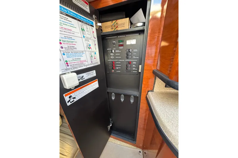 Slide: The Image of Electrical panel inside a 2006 Searay 260 boat, featuring control switches and safety instructions. - 32