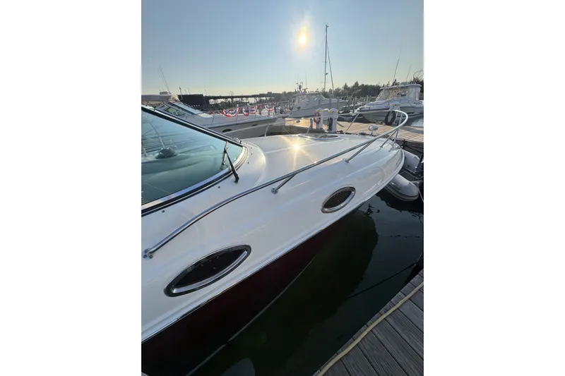 Slide: The Image of 2006 Sea Ray 270 Sundancer docked at marina under bright sun. - 3