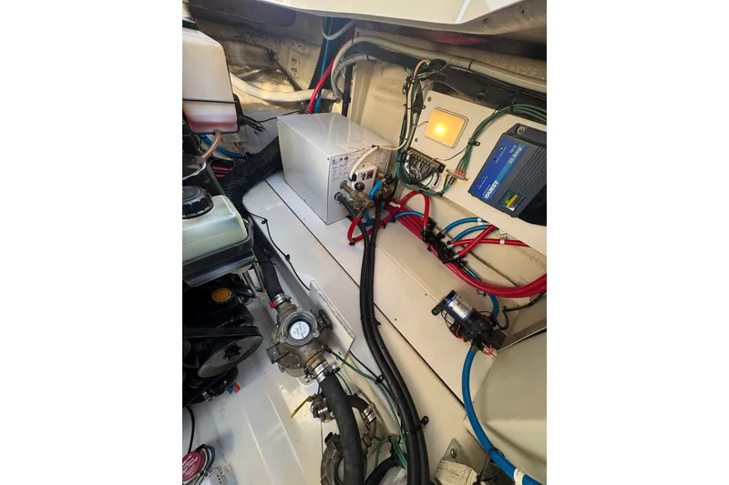 Slide: The Image of Engine compartment of a 2006 Searay 260 boat, showcasing wiring and components. - 21
