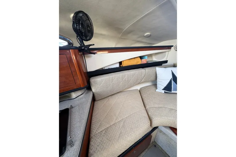 Slide: The Image of Interior of a 2006 Searay 260 boat with beige seating and wooden accents. - 29