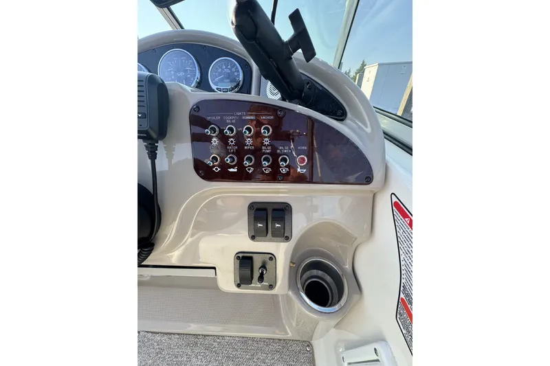 Slide: The Image of Dashboard controls of a 2006 Sea Ray 270 Sundancer boat. - 10