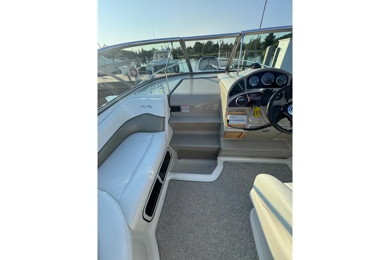 Slide: The Image of 2006 Searay 260 boat interior with steering wheel and seating area. - 16