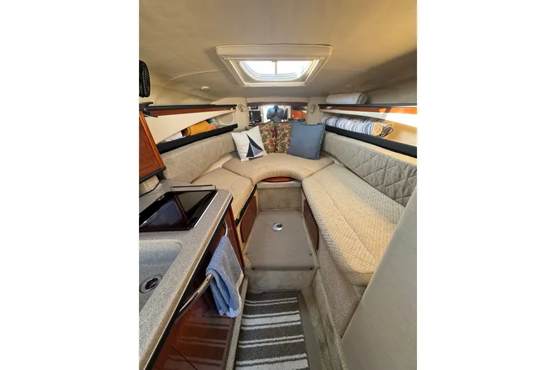 Slide: The Image of Interior of a 2006 Searay 260 boat with cozy seating and elegant design. - 31