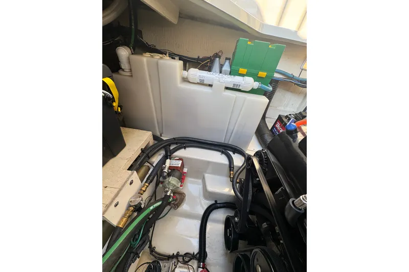 Slide: The Image of Engine compartment of a 2006 Searay 260 boat, showcasing wiring and components. - 26