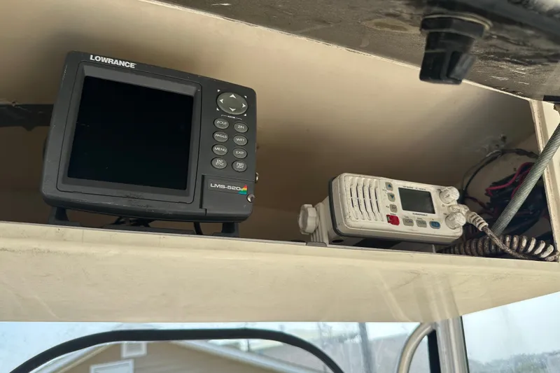 Slide: The Image of Boat electronics on a 2004 Jones Brothers Bateau 20, featuring Lowrance LMS-520 and marine radio. - 19
