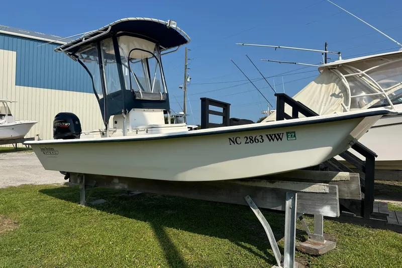 The Image of 2004 Jones Brothers Bateau 20 boat on display, featuring a sleek design and outboard motor. - 1