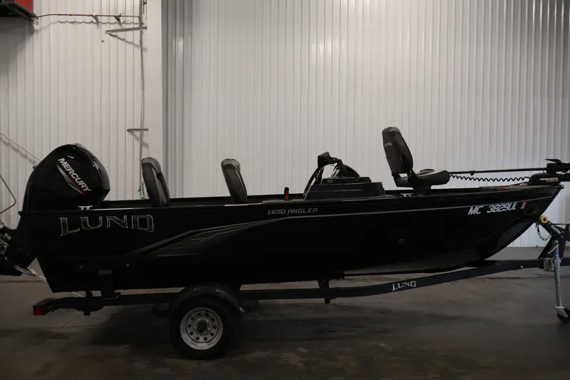 Slide: The Image of 2020 Lund 1650 Angler SS fishing boat with Mercury engine in indoor storage. - 4