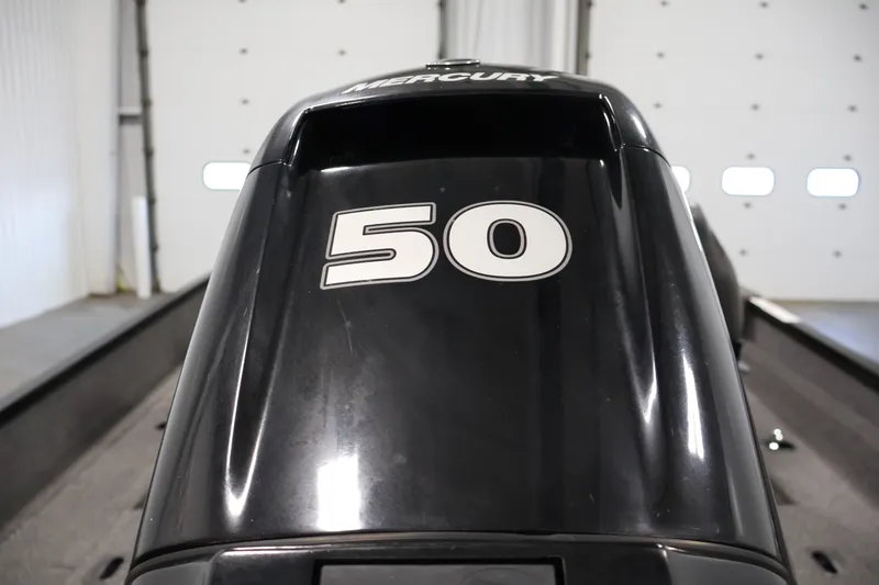 Slide: The Image of 2020 Lund 1650 Angler SS with Mercury 50 HP outboard engine in a garage setting. - 37