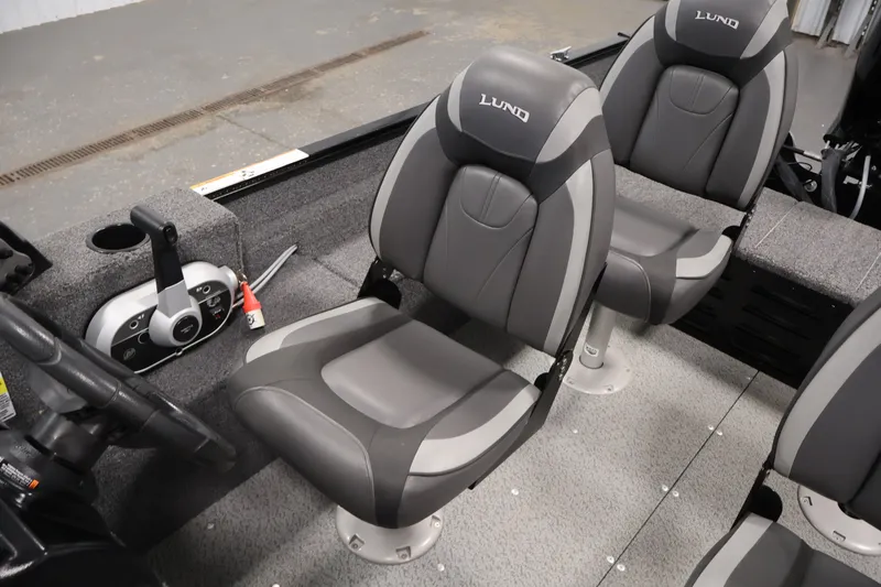 Slide: The Image of 2020 Lund 1650 Angler SS boat interior with gray seating and control panel. - 29