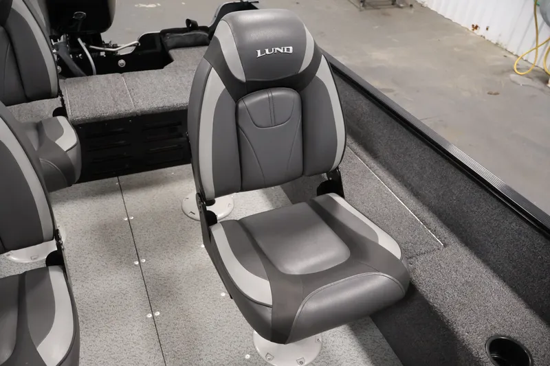 Slide: The Image of 2020 Lund 1650 Angler SS boat interior with gray seating and carpeted flooring. - 30