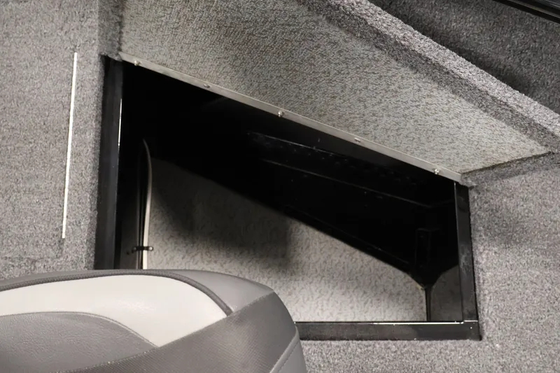Slide: The Image of 2020 Lund 1650 Angler SS boat interior storage compartment with gray upholstery. - 15