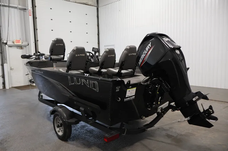 Slide: The Image of 2020 Lund 1650 Angler SS fishing boat with Mercury outboard motor in a garage setting. - 7
