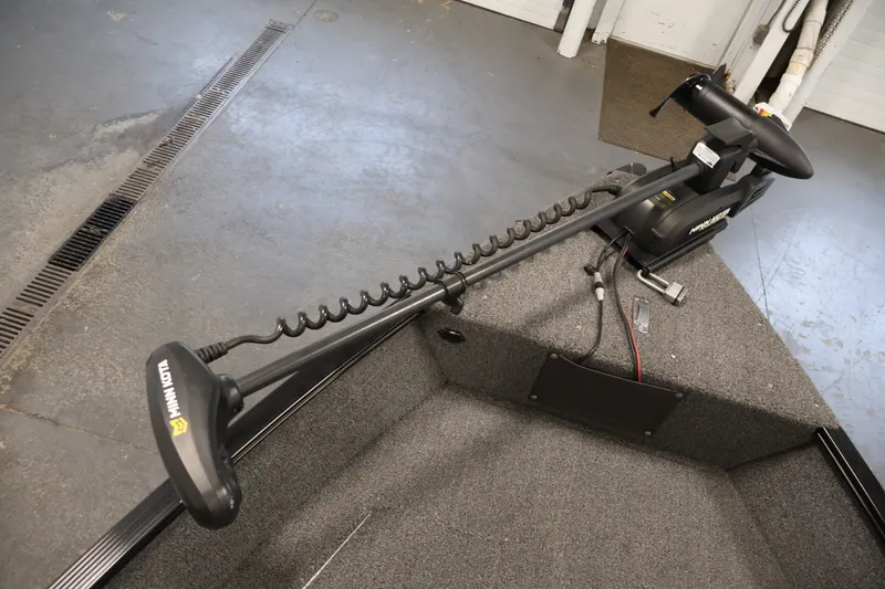 Slide: The Image of 2020 Lund 1650 Angler SS boat with Minn Kota trolling motor in a garage setting. - 11