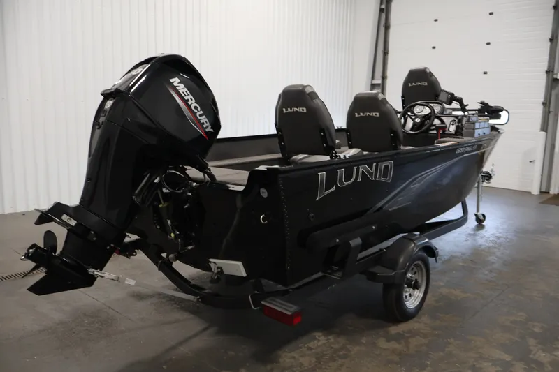 Slide: The Image of 2020 Lund 1650 Angler SS boat with Mercury outboard motor in a garage setting. - 5