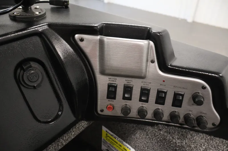 Slide: The Image of Control panel of a 2020 Lund 1650 Angler SS boat with switches and 12V outlet. - 27