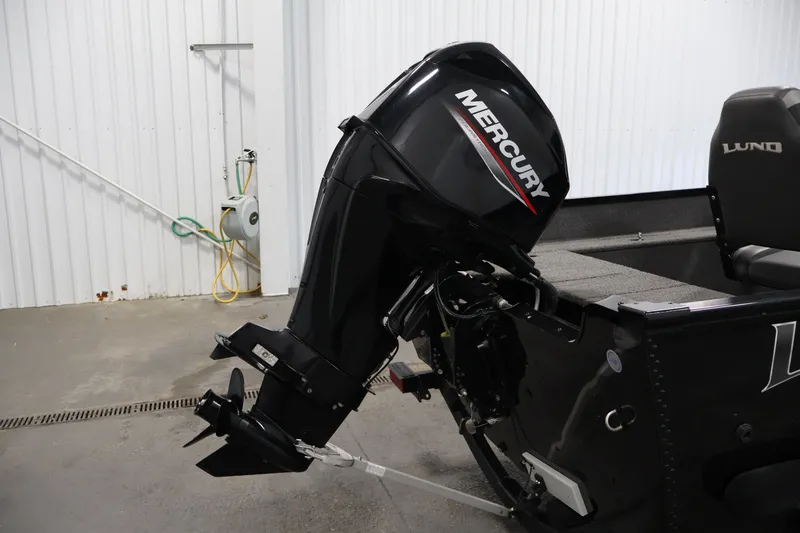 Slide: The Image of 2020 Lund 1650 Angler SS boat with Mercury outboard motor in a garage setting. - 36