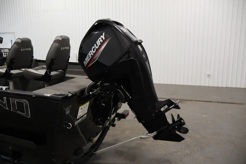 Slide: The Image of 2020 Lund 1650 Angler SS boat with Mercury outboard motor in a garage setting. - 35