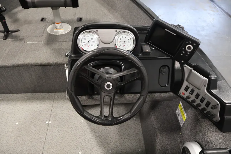Slide: The Image of 2020 Lund 1650 Angler SS boat dashboard with steering wheel and electronic controls. - 23