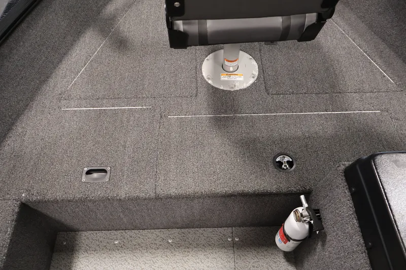 Slide: The Image of 2020 Lund 1650 Angler SS boat interior with gray carpet and fire extinguisher. - 18